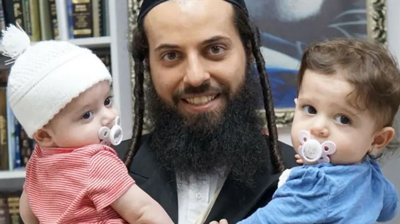 Rafi holding his kids
