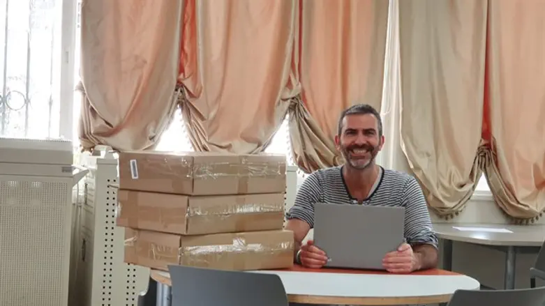 המנהל ירון כרמי עם חלק מהמחשבים
