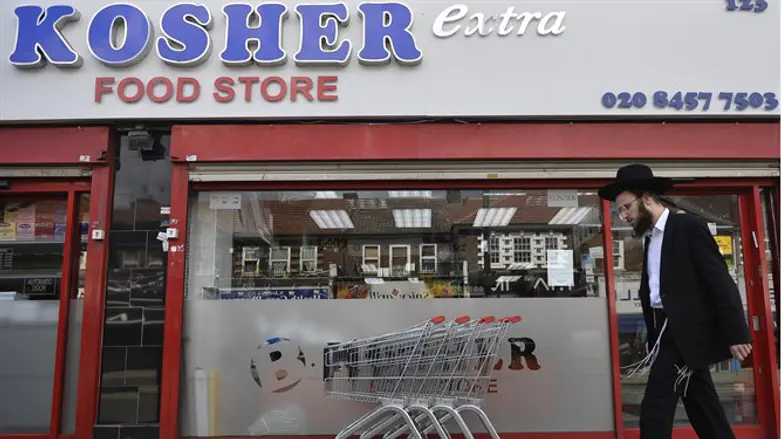 Man walks past kosher store, Golders Green