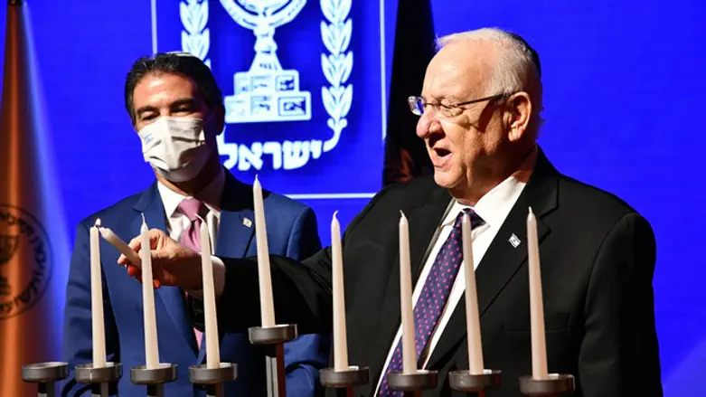 Rivlin and Cohen light Hanukkah candles